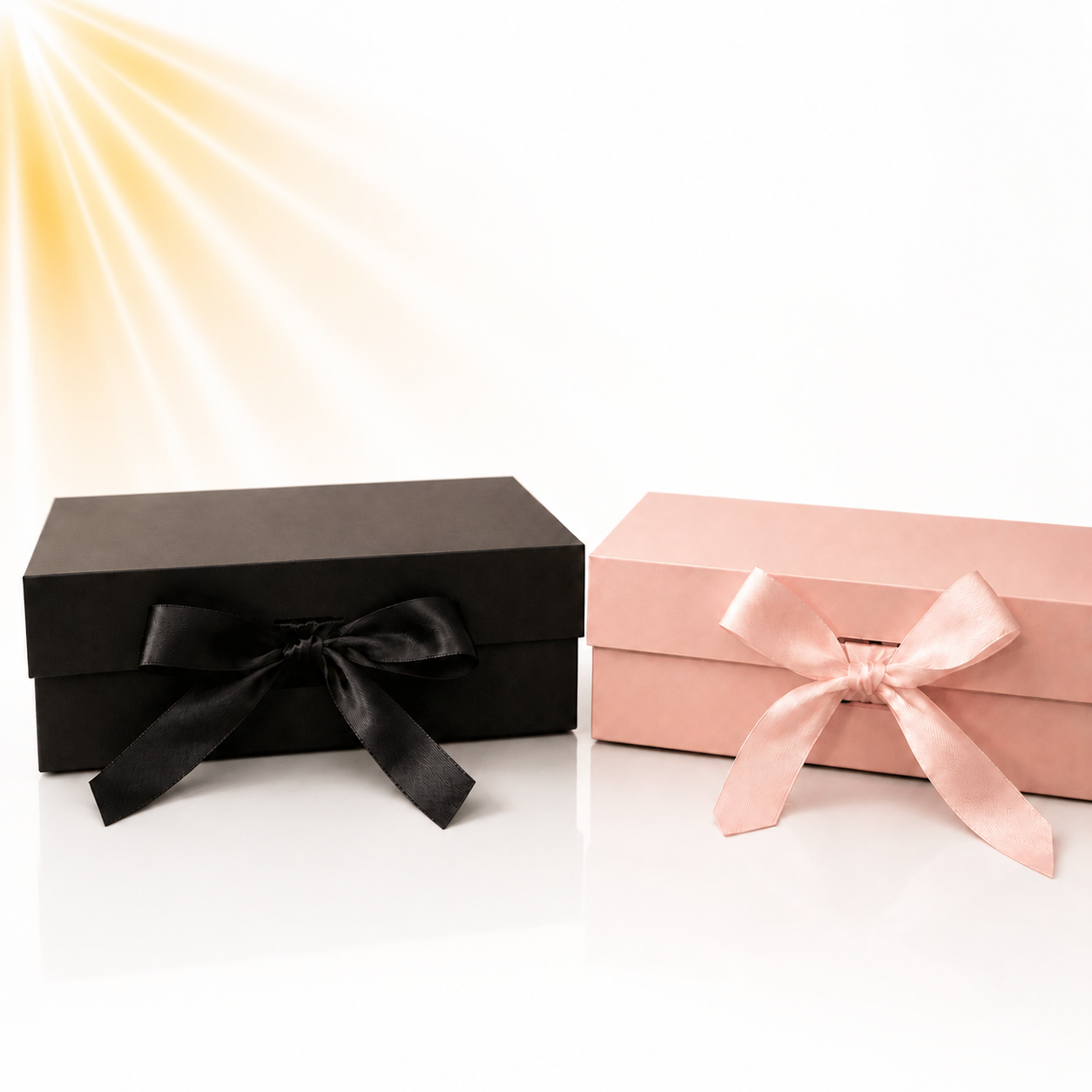 Luxe geschenkpakketten van Elluxuryparfum in zwart en roze met sierlijke strik.
